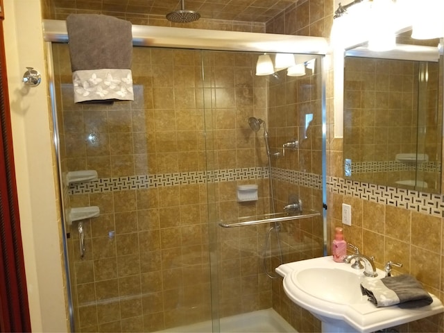 bathroom featuring a sink and a shower stall