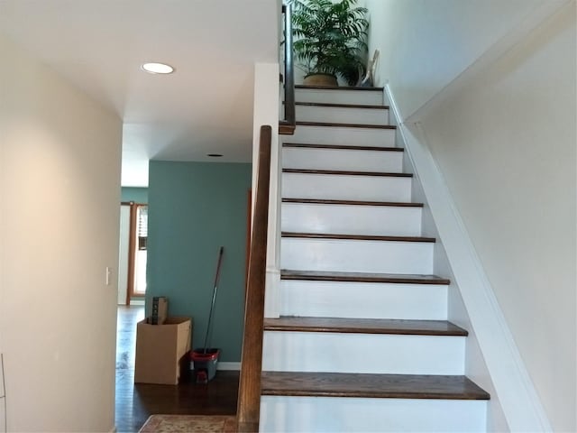 stairway with recessed lighting, wood finished floors, and baseboards