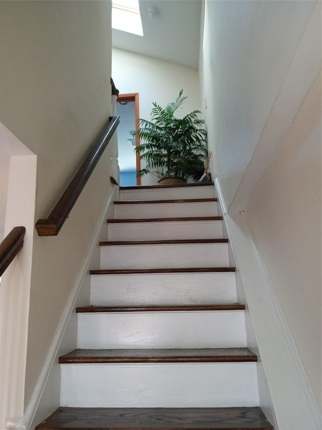 stairs featuring a skylight