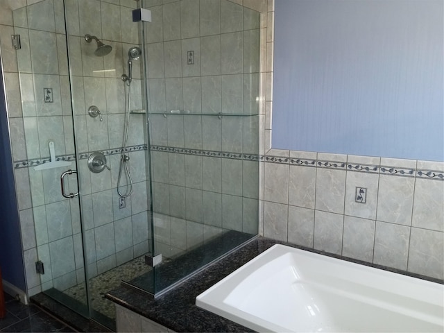 bathroom with a garden tub and a stall shower