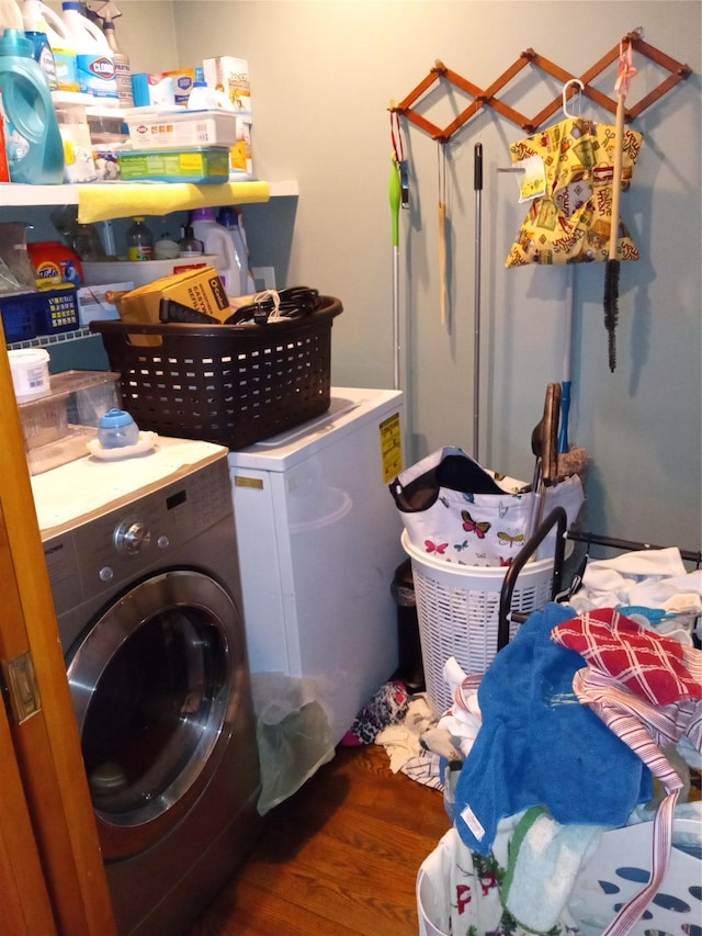 clothes washing area with laundry area and wood finished floors