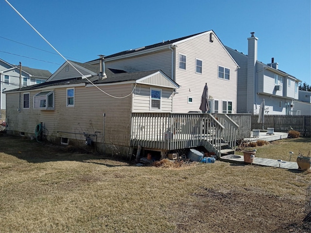 back of house with a yard, a wooden deck, and fence