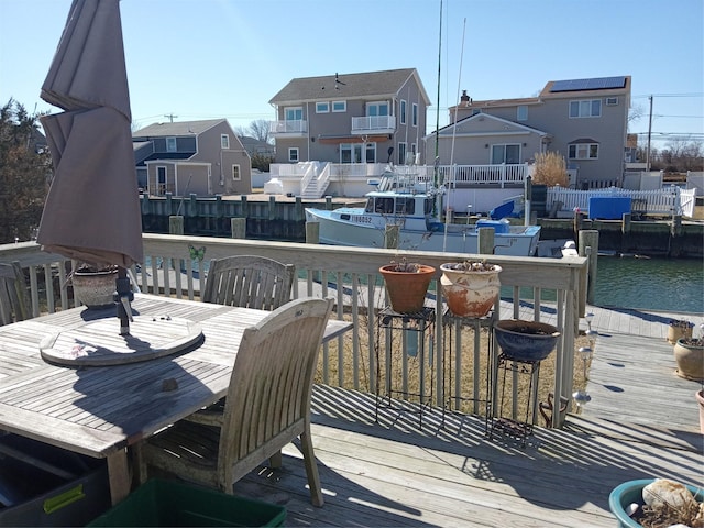 deck featuring a residential view and a water view