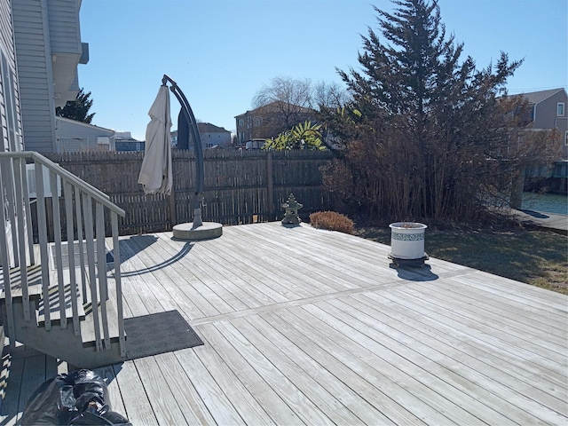 wooden terrace featuring fence