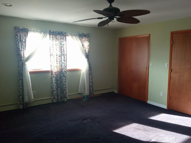 spare room with a baseboard heating unit, baseboards, carpet, and a ceiling fan