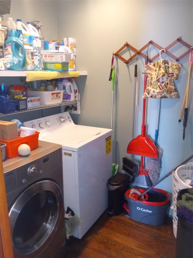 clothes washing area featuring laundry area, separate washer and dryer, and wood finished floors