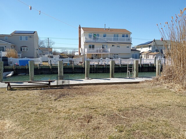2706 Peconic Ave, Seaford, NY 11783 - dock area with a water view, a residential view, and a lawn