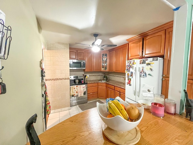 5822 Van Cleef St, Corona, NY 11368 - kitchen with light tile patterned flooring, ceiling fan, a sink, stainless steel appliances, and glass insert cabinets