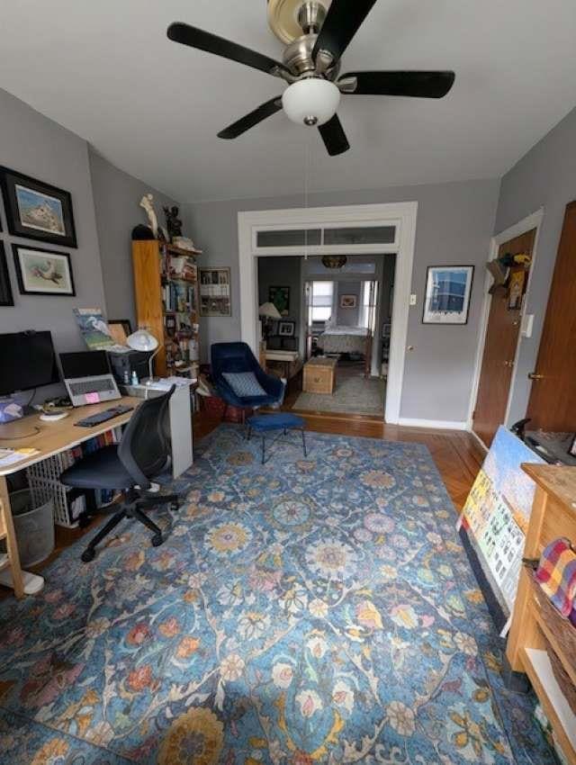 office space with a ceiling fan and wood finished floors