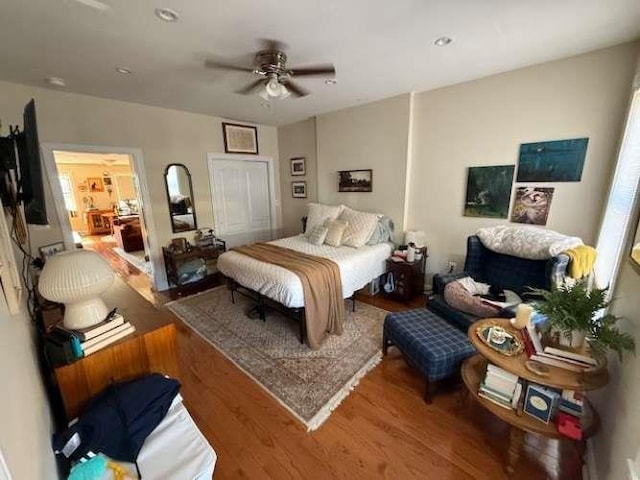 bedroom with a ceiling fan and wood finished floors