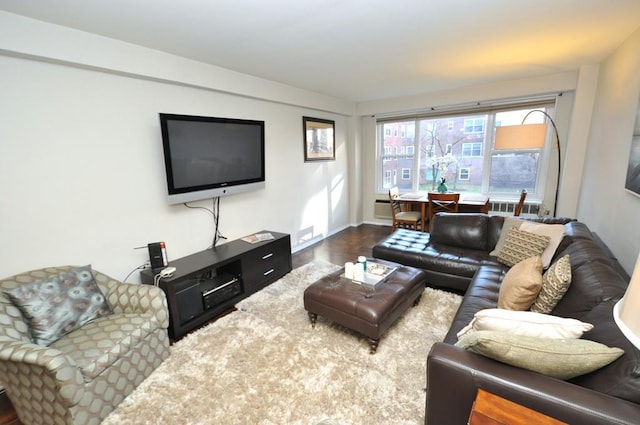 living area with baseboards and wood finished floors