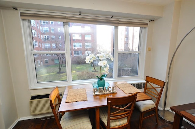 dining room with baseboards and a wall mounted air conditioner