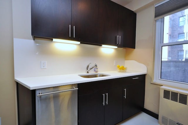 kitchen with dishwasher, light countertops, radiator heating unit, and a sink