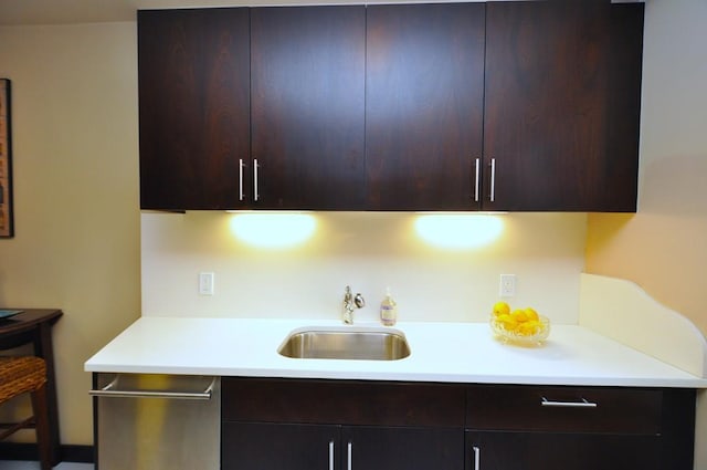 kitchen featuring a sink, dark brown cabinets, light countertops, modern cabinets, and stainless steel dishwasher