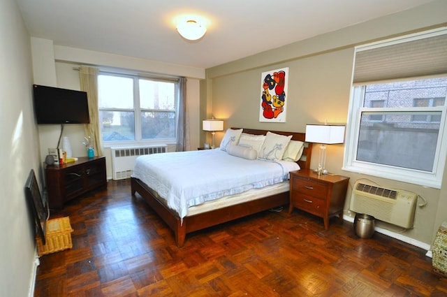 bedroom featuring radiator and a wall unit AC