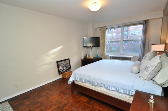 bedroom with baseboards and radiator heating unit