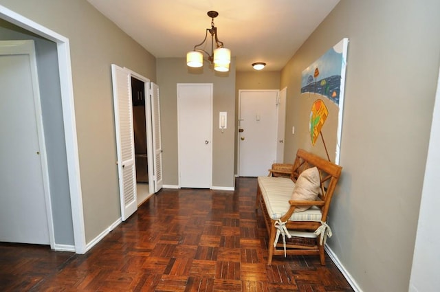 entrance foyer with baseboards and a chandelier