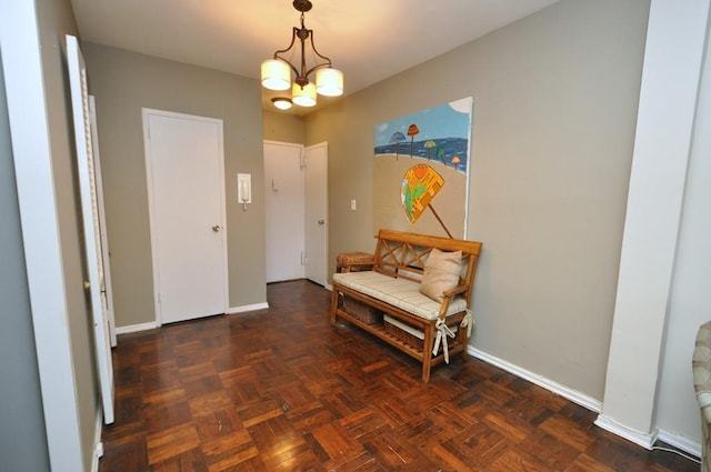 interior space featuring a chandelier and baseboards