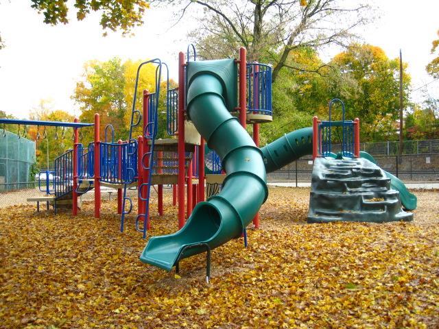 communal playground featuring fence