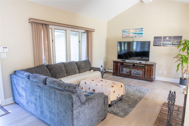 living room with a baseboard radiator, lofted ceiling, baseboards, and wood finished floors