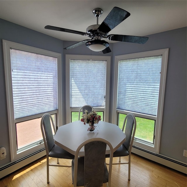 dining area featuring light wood-type flooring and baseboard heating