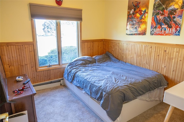 carpeted bedroom featuring a baseboard radiator, wood walls, and wainscoting