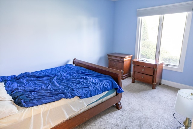 bedroom with baseboards and carpet floors