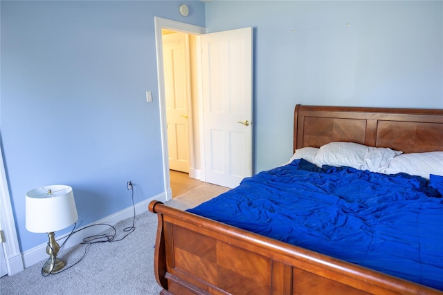 carpeted bedroom featuring baseboards