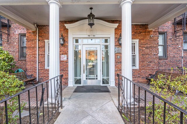 doorway to property with brick siding