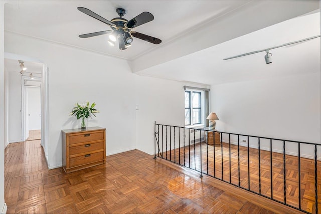 spare room with baseboards and ceiling fan