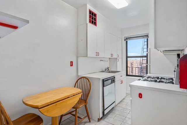 kitchen featuring dishwasher, light countertops, white cabinetry, and a sink