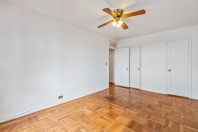 unfurnished bedroom featuring baseboards and ceiling fan