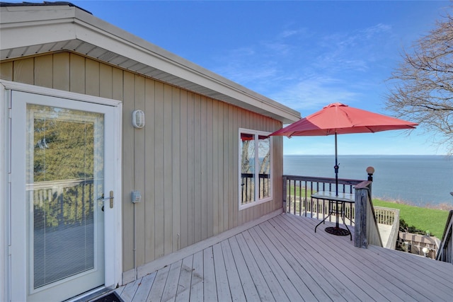wooden deck featuring a water view