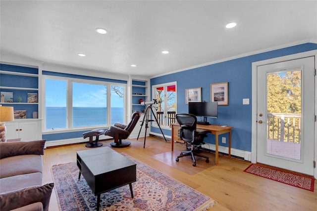 office space featuring built in features, wood finished floors, recessed lighting, crown molding, and baseboards