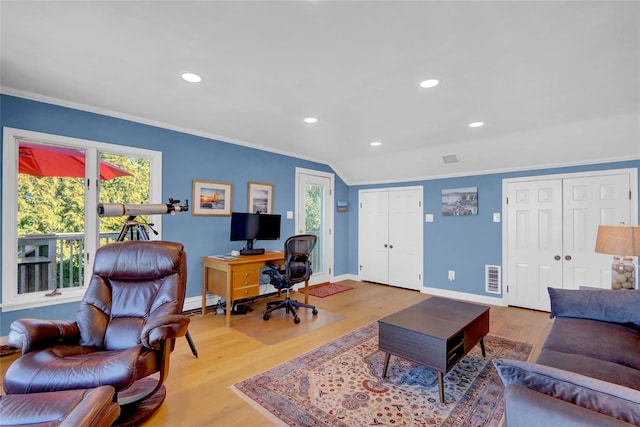 home office featuring crown molding, wood finished floors, visible vents, and baseboards