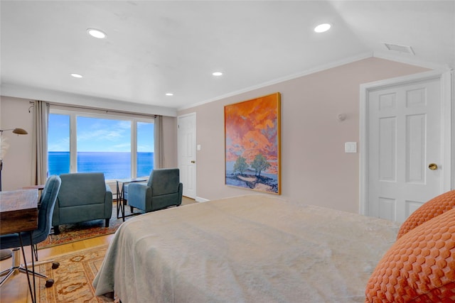 bedroom featuring light wood-type flooring, a water view, visible vents, recessed lighting, and lofted ceiling
