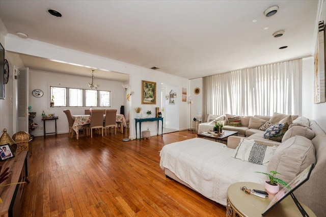 living room with an inviting chandelier and hardwood / wood-style floors