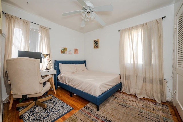 bedroom with ceiling fan and wood finished floors