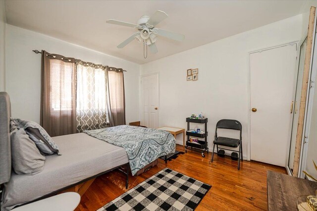 bedroom with a ceiling fan and wood finished floors