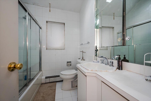 bathroom featuring a baseboard heating unit, bath / shower combo with glass door, toilet, tile patterned floors, and tile walls