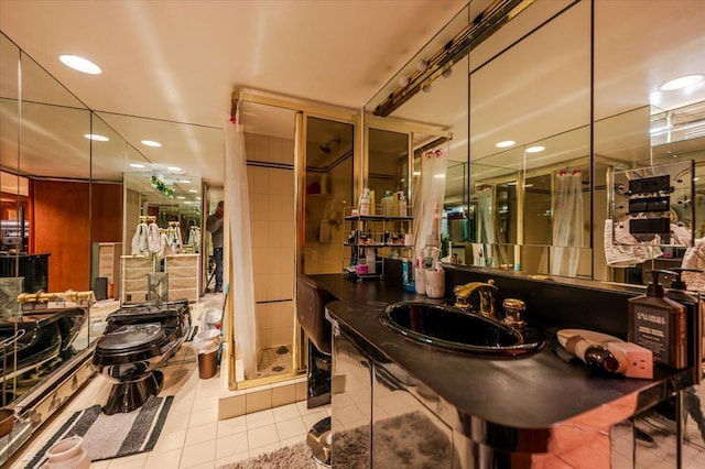 bathroom featuring a sink, recessed lighting, a stall shower, and tile patterned floors