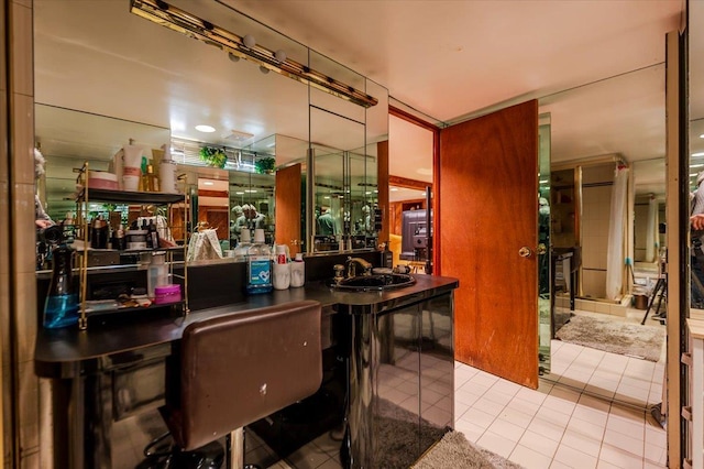 bar featuring tile patterned floors and a sink