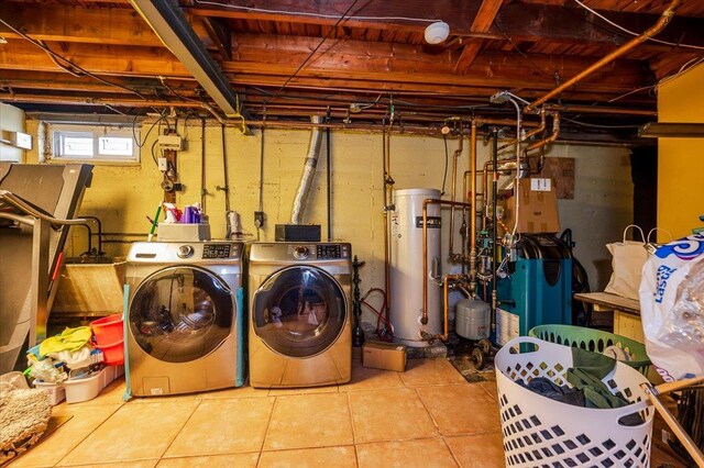 laundry room featuring water heater, laundry area, and washing machine and clothes dryer