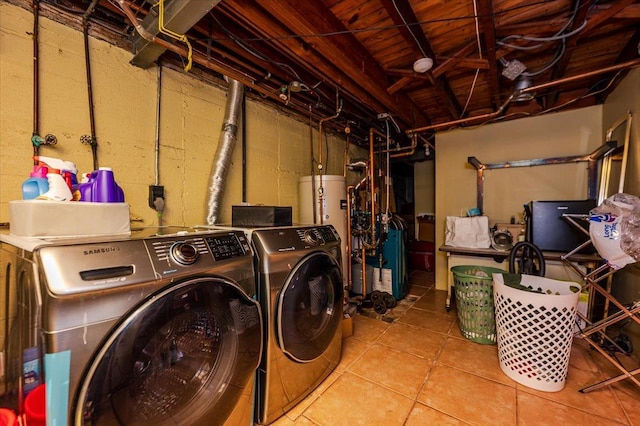 laundry room featuring washing machine and dryer, water heater, tile patterned flooring, a heating unit, and laundry area