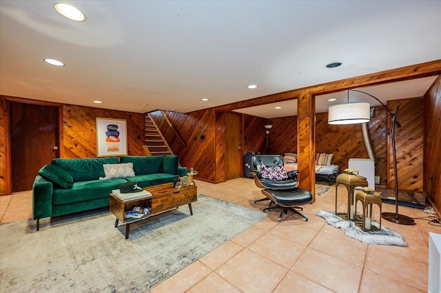 tiled living area with recessed lighting, stairway, and wood walls