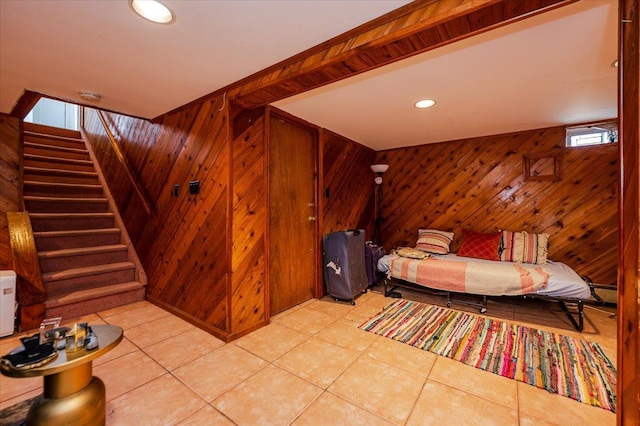 bedroom featuring recessed lighting, wood walls, and light tile patterned flooring