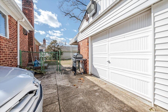 garage featuring a gate and fence