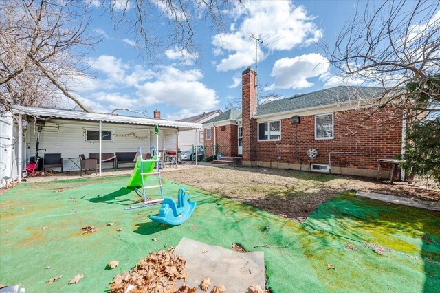 rear view of house with brick siding and a chimney