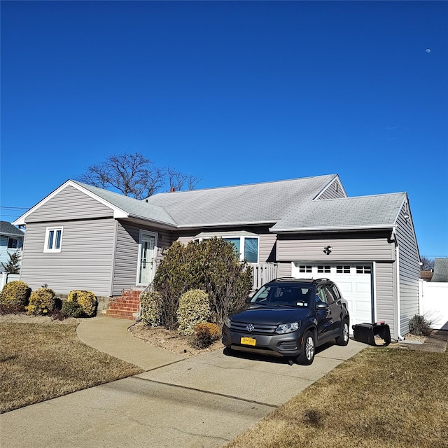 view of property exterior featuring an attached garage, driveway, and roof with shingles