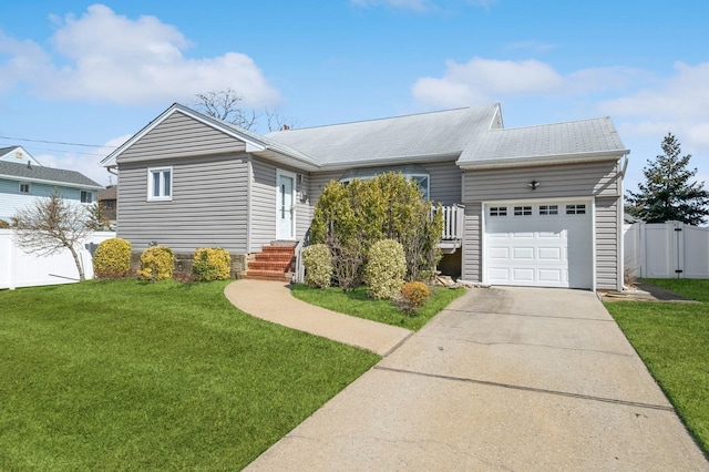 single story home with a front lawn, entry steps, fence, concrete driveway, and a garage